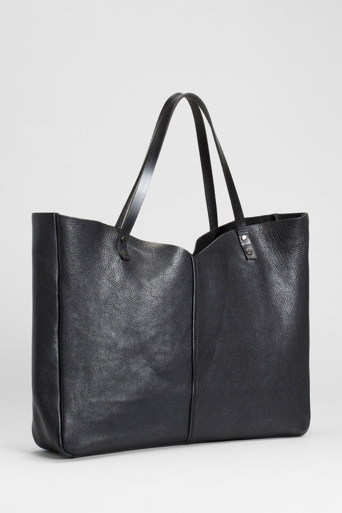 Large leather tote bag, perfect for a weekend get away or everyday use. Fits all sized laptops. Has zip up compartments for storage. 